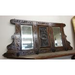 A carved oak hall mirror