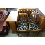 An oak drop leaf table and four chairs