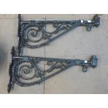A pair of cast iron brackets