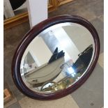 An oval mahogany framed mirror