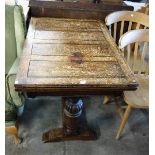 An oak draw-leaf dining table