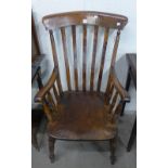 A Victorian style elm and beech farmhouse armchair