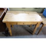 A pine kitchen table with a single drawer