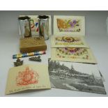 Four silk postcards, a pair of trench art shell vases, etc.