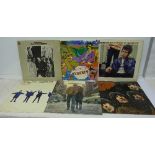 A collection of LP records including The Beatles Revolver, Help!,