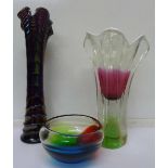 A purple carnival glass vase and two coloured glass vases,