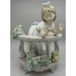 A Lladro figure, girl on a balcony, some petals a/f,