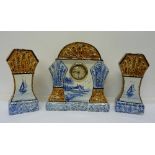 A French pottery clock garniture, marked MW,