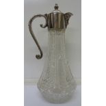 A glass claret jug with plated top