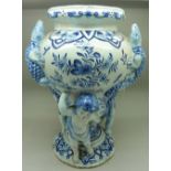 A Delft vase decorated with cherubs and lizards, height 27.