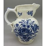 A Worcester blue and white mask jug, with crescent mark,