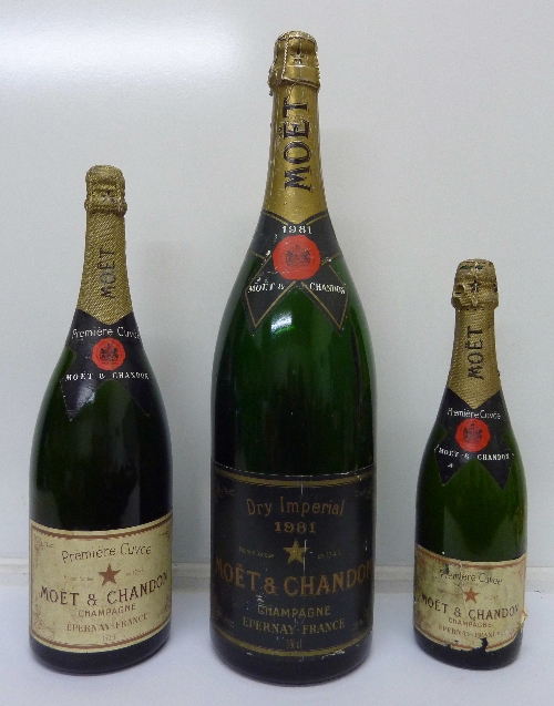 Three display bottles of Moet & Chandon champagne,