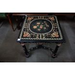 An ebonised and painted top occasional table