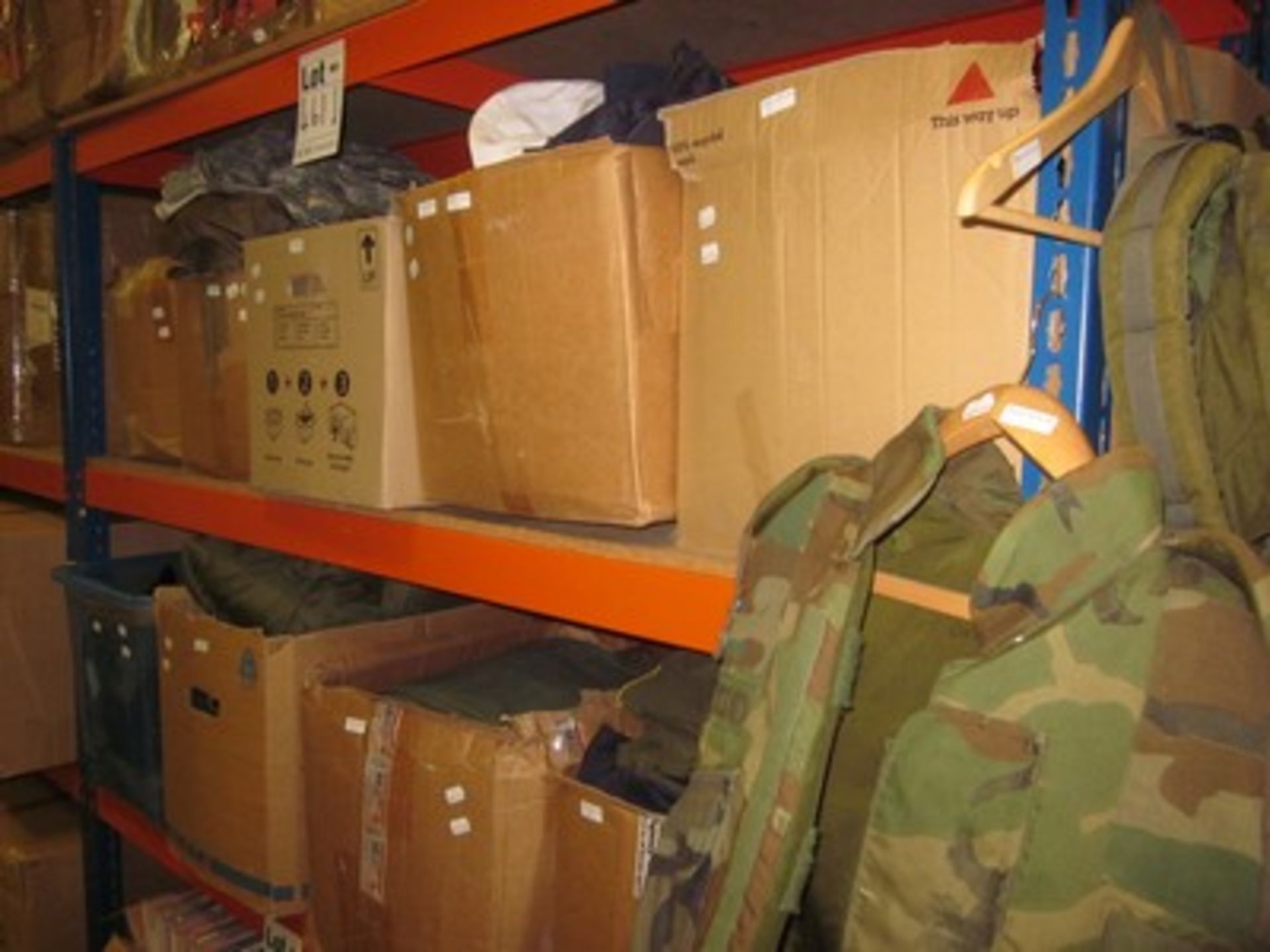 Nine boxes of US Army and Navy military surplus including combat jackets, trousers, caps and t-