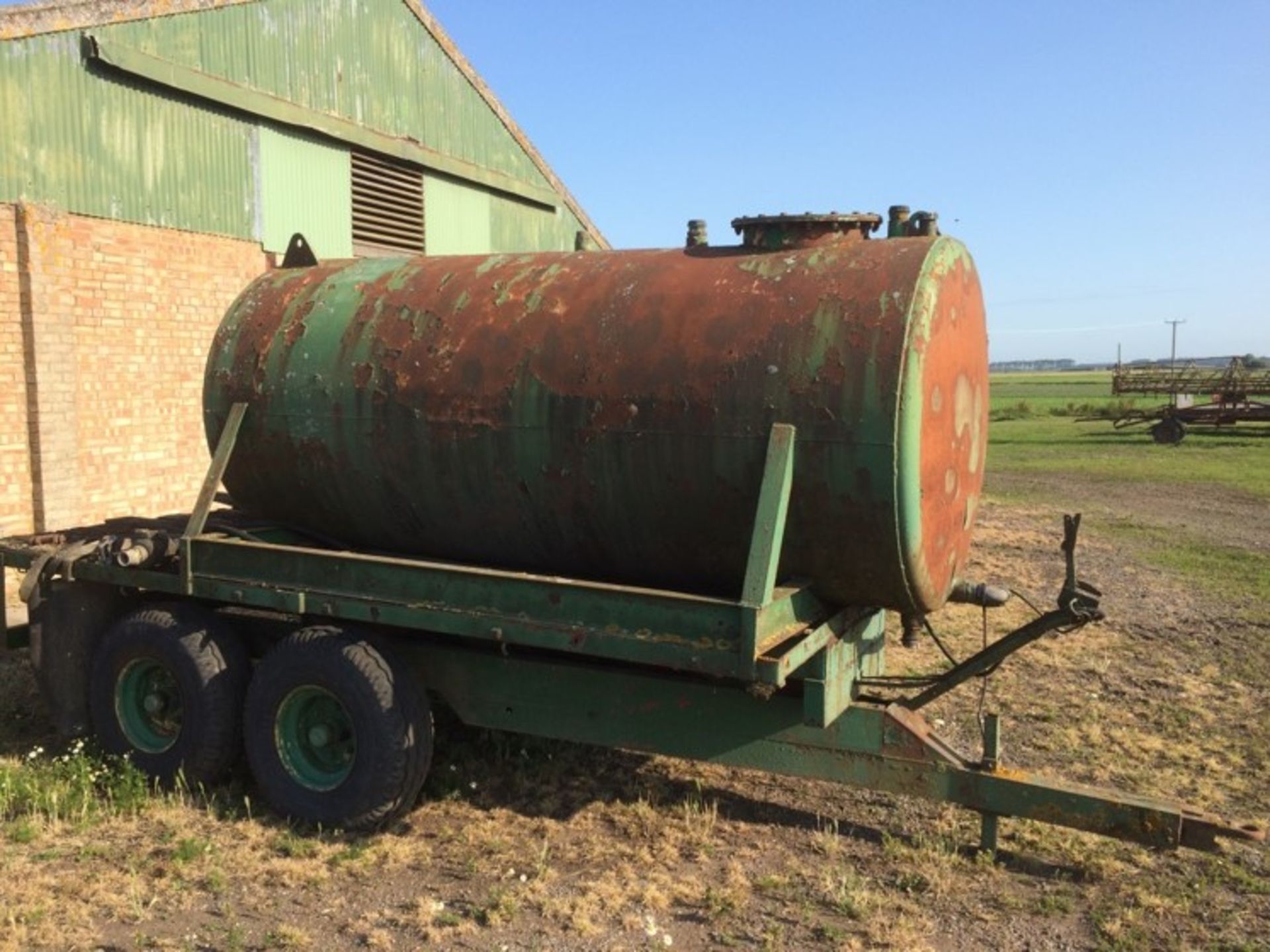 Trailed water bowser mounted on wooden bed trailer. Location Brandon, Suffolk