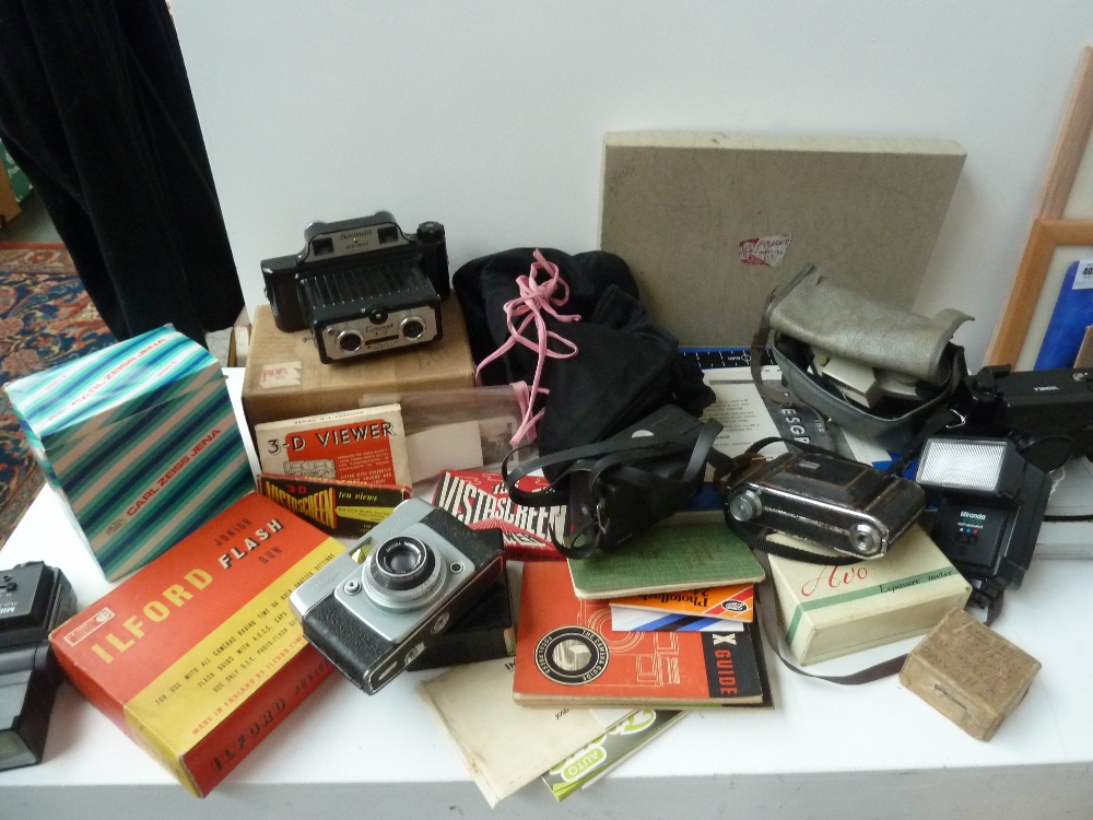 A box of 35mm cameras, flash units and o