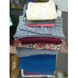 A box of woollen dressmaking fabrics, in