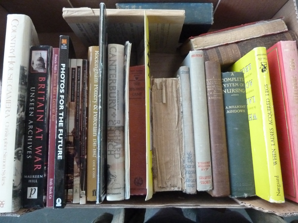 A tray of various books, including The M