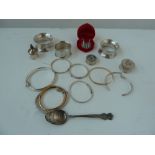 Three silver napkin rings, several silve