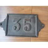 A cast iron house number '35', 33cmW x 1