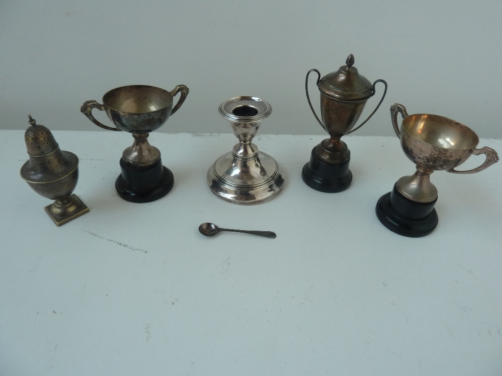A number of silver trophies on plinths,