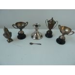 A number of silver trophies on plinths,