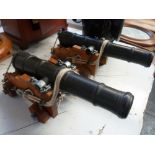 A pair of desk cannons mounted on wooden