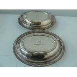 A pair of silver plated lidded tureens,