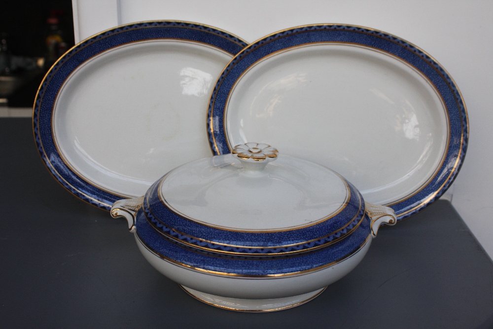 A Booths Pottery part dinner service to include graduating size meat platters, tureen dishes,