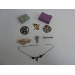 A selection of jewellery including, a Celtic circular brooch, a circular wreath brooch with four