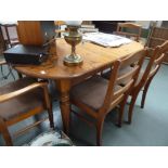 A pine dining table with turned legs wit