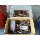 A box of vintage tools including hammers