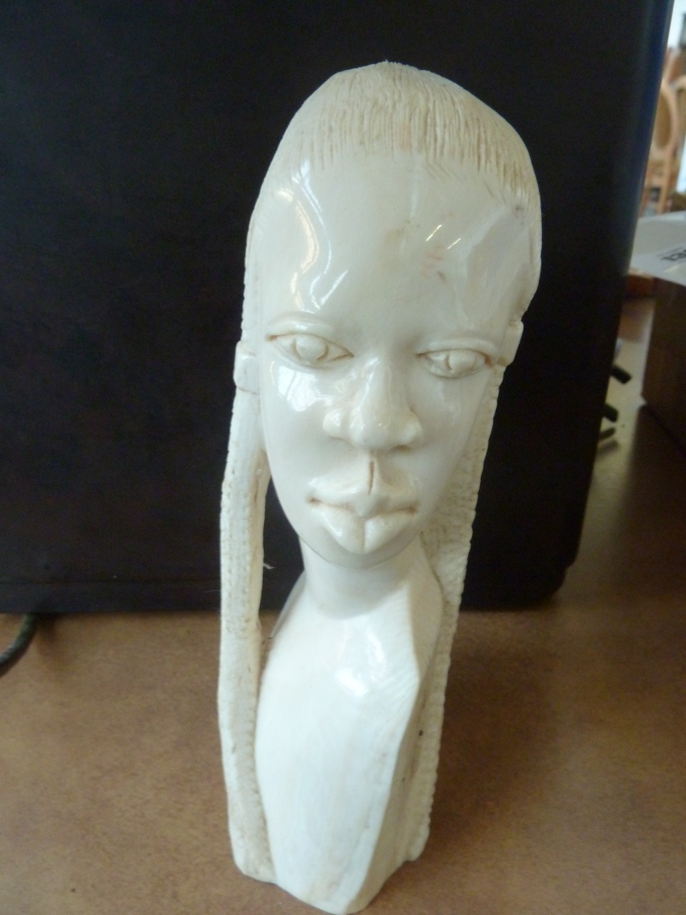 An early 20th century carved ivory tusk in the form of an African lady, 18cmH, (660g)