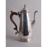 A George II silver coffee pot, London 1744, tapering circular form, foliate-scroll engraving,