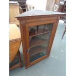 An oak glazed corner cabinet, three internal shelves,