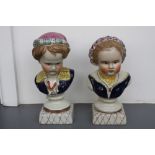 A pair of Staffordshire pottery busts of a young girl and boy, hand painted over cream ground,