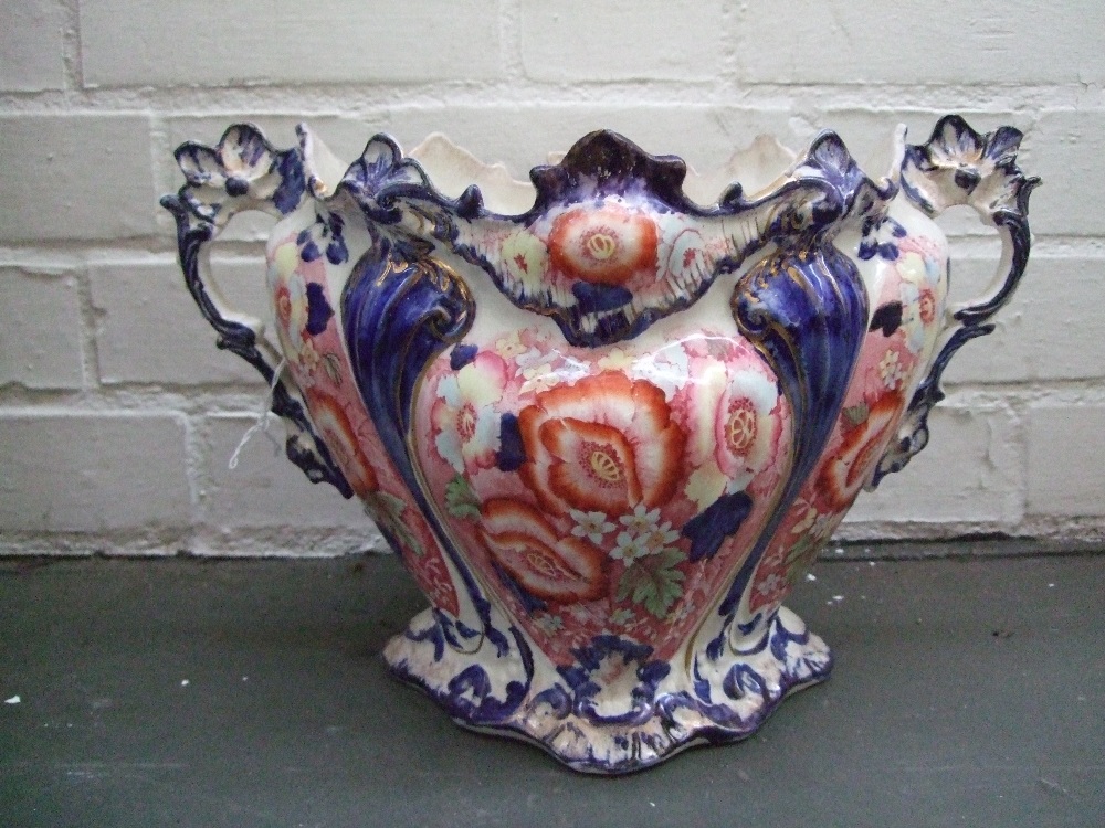 A large Edwardian Jardiniere decorated with hand painted poppies and flowers over red transfer,