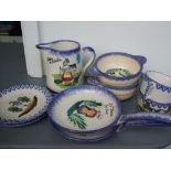 A collection of hand painted French pottery to include cups, saucers and small bowls.