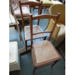 A pair of Edwardian mahogany and satinwood banded bedroom chairs with wicker seats