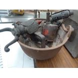 An early 20th century cast iron plumbers pot with swing handle, a boot jack in the form of a beetle,