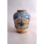 A 17th century Safavid pottery vase, of baluster form, blue underglaze with cusped panels,