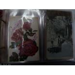 an album of postcards in a red album, including flowers,