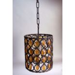 A 1950's/60's wrought-iron and amber glass hall lantern, cylindrical, fitted electricity,