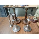 A pair of 20th century oak barley twist candle sticks, with brass sconces,