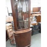 A 20th century mahogany corner display cabinet, glazed top over domed cupboard,