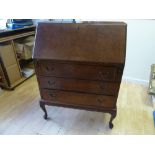 A 20th century walnut veneer bureau, drop down front over three drawers,