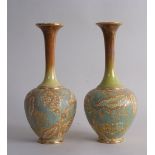 A pair of Royal Doulton vases by Ellen Palmer, dated 1894-6, decorated with floral and gilt motifs,