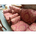 A 20th century three piece suite, upholstered in red and gold foliate decoration,