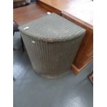 A green painted wicker corner laundry basket,