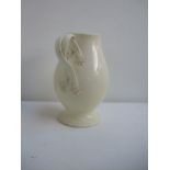 Leeds Pottery cream glaze jug with with scrolling ribbon handles and applique floral motifs,